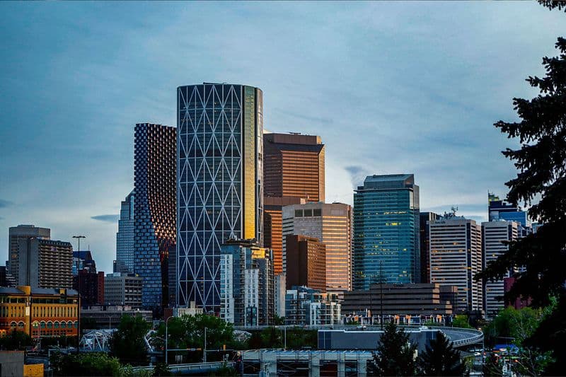 Downtown Calgary skyline with the iconic Calgary Tower illuminated at blue hour.